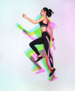 Attractive woman doing stretching exercise or yoga moves with glitch duotone effect