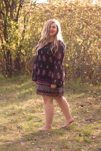 Portrait of smiling woman standing in park