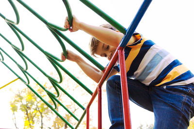 Low angle view of boy on grassy field