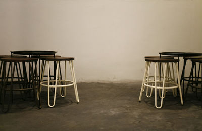 Empty chairs and table against wall at home