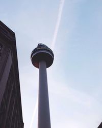 Low angle view of communications tower against sky