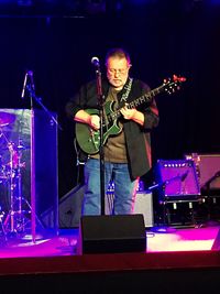 Man playing guitar at music concert