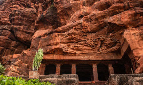 Badami cave temple interior pillars stone art in details