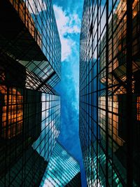 Directly below shot of modern glass building against sky