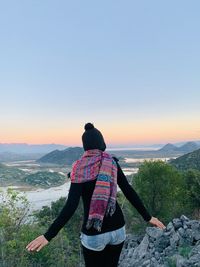 Rear view of man looking at mountain against sky