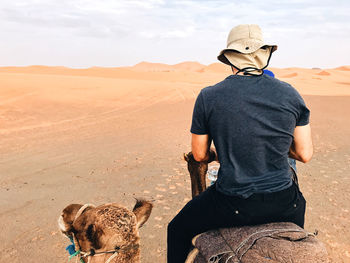 Rear view of  man on desert land