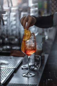 Close-up of hand pouring wine in glass