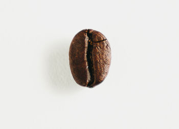 Directly above shot of coffee beans against white background