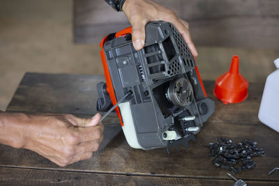 Cropped hand of man working on table