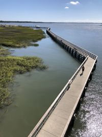 High angle view of pier over lake against sky