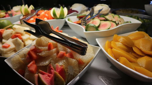 Close-up of chopped fruits in plate on table