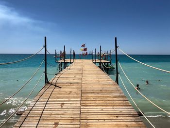 Pier over sea against clear sky