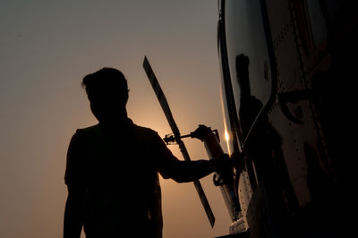 Low angle view of silhouette man standing against sky