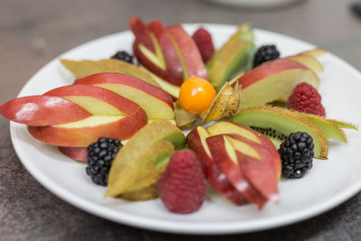 Close-up of fruits in plate on table