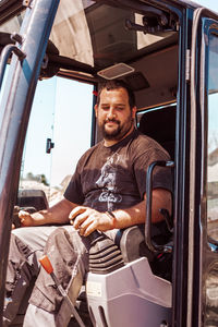Portrait of man working at bus