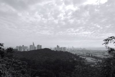 City skyline against cloudy sky