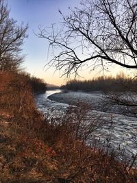 Scenic view of lake against sky during winter