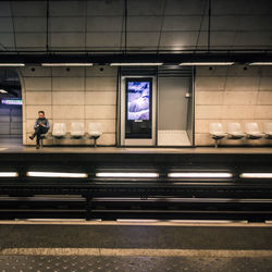 People waiting at railroad station platform