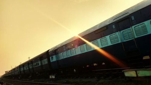 Train at railroad station against clear sky