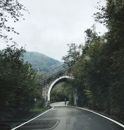 Road by mountain against sky