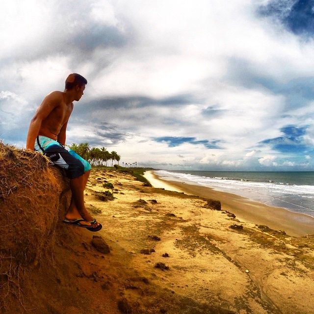 beach, sea, sand, shore, lifestyles, sky, water, horizon over water, leisure activity, full length, vacations, casual clothing, cloud - sky, scenics, tranquil scene, standing, nature, beauty in nature