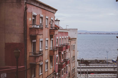 Buildings against cloudy sky