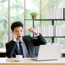 Man using mobile phone at table