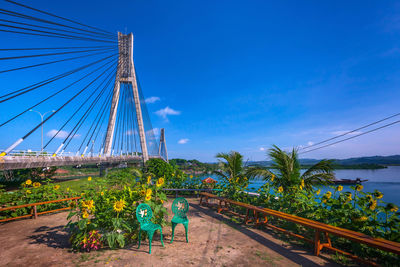 Low angle view of bridge against blue sky