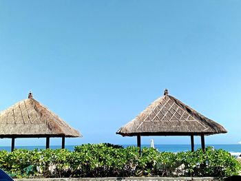 Gazebo by building against clear blue sky