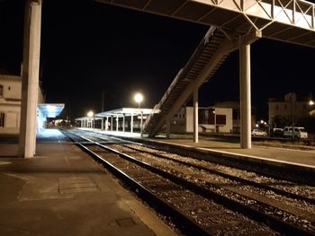 Train on railroad station platform at night