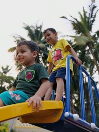 Portrait of boy sitting on play equipment