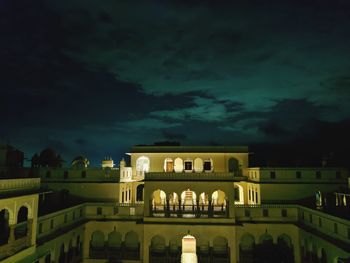 Illuminated building against sky at night