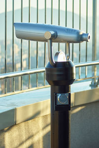 Close-up of metal railing by window