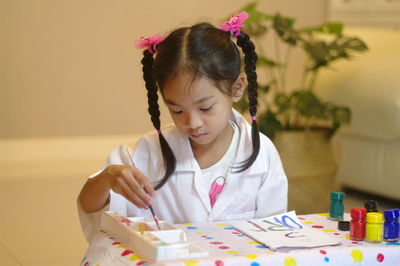 Portraits of cute asian girls playing and painting with joy