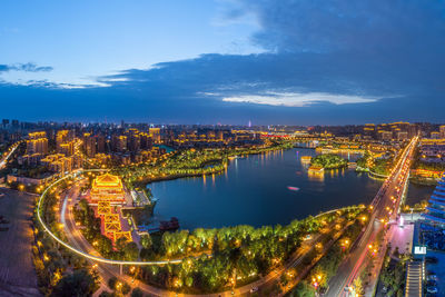 High angle view of illuminated buildings in city during dusk