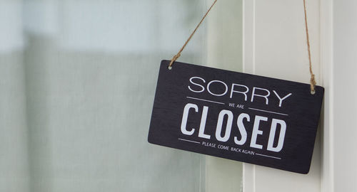 Close-up of information sign on wall