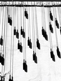 Low angle view of hanging lights against sky