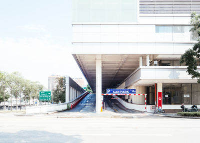 Road by building against sky