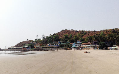 Houses on seashore against mountains at arambol beach