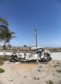 Abandoned vehicle on beach against clear sky