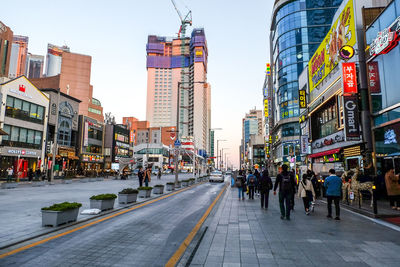 City street and buildings against sky