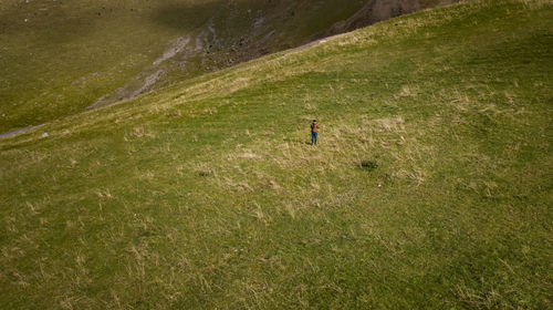 High angle view of man walking on grass field