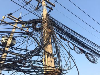Low angle view of electricity pylon against sky