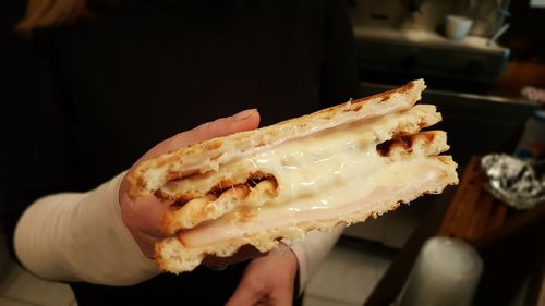 Midsection of woman eating fresh breakfast bread