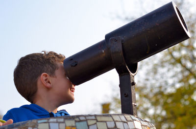 Boy looking through telescope