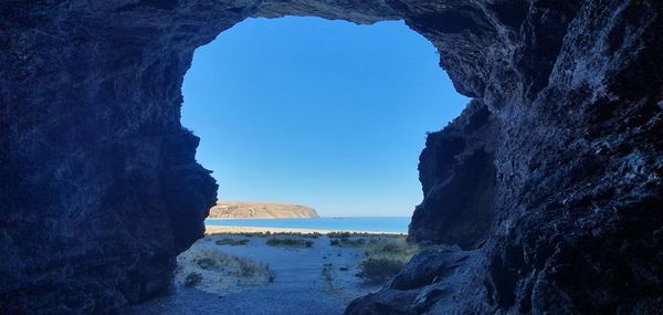 Rock formations in sea against sky