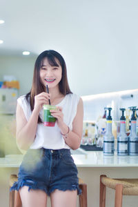 Young woman drinking glass