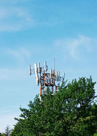 Low angle view of communications tower against sky