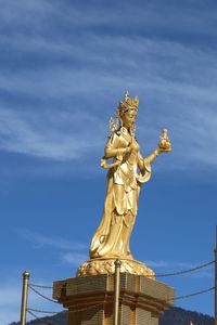 Low angle view of statue against cloudy sky