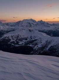 Scenic view of snow covered mountains against sky during sunset